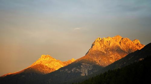 Scenic view of mountain range against sky during sunset