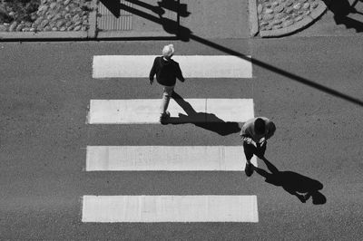 High angle view of people crossing road