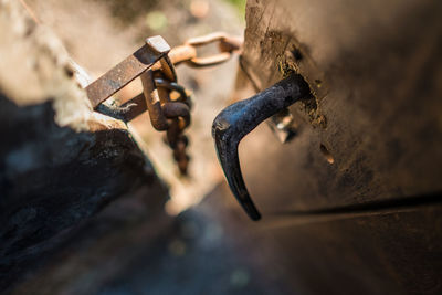 High angle view of rusty metallic handle on weathered wooden door