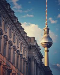 Low angle view of building against cloudy sky