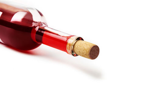 Close-up of red bottles against white background