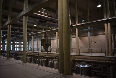 Rear view of man standing in illuminated building