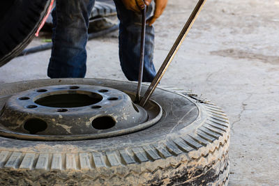 Car mechanic changing tire on the rim in service garage