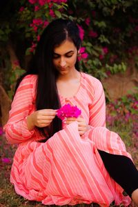 Woman sitting on pink flower