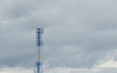 Low angle view of communications tower against sky