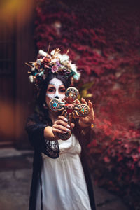 Young woman holding christmas decoration