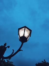 Low angle view of street light against blue sky