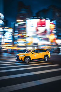 Blurred motion of car on city street at night