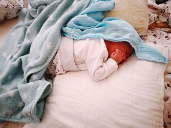 High angle view of cute baby boy sleeping on bed at home