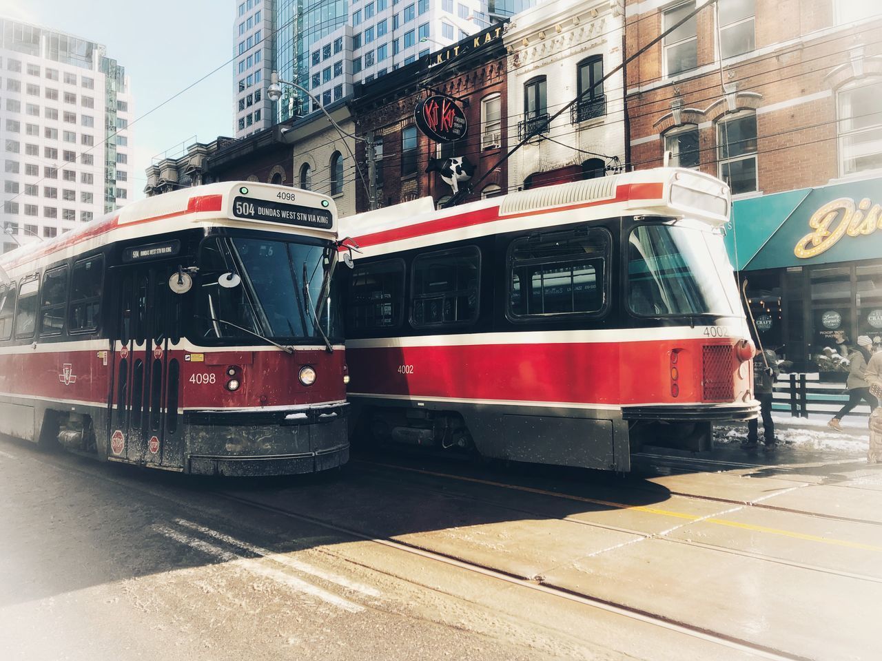 VIEW OF RED CAR ON CITY