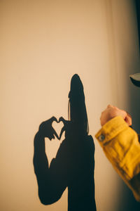 Silhouette woman standing against wall