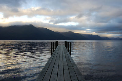 Pier over lake against sky