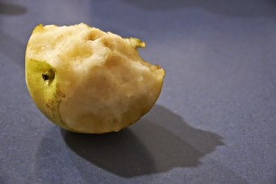 Half-eaten pear on floor