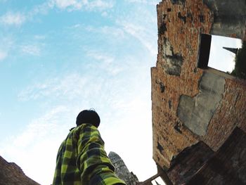 Rear view of man standing against sky