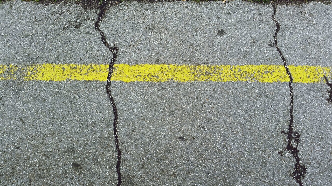 yellow, street, road marking, asphalt, transportation, road, high angle view, textured, full frame, backgrounds, outdoors, day, no people, close-up, pattern, the way forward, direction, detail, sunlight, wet