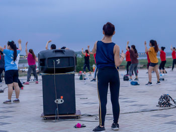 Rear view of people walking on road