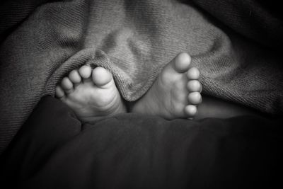 Close-up of baby feet on bed