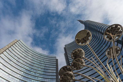 Low angle view of sculpture on building against cloudy sky