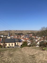 High angle view of townscape against clear blue sky