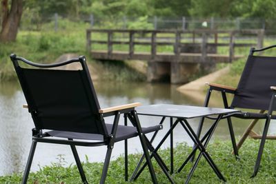 Empty chairs and tables in yard