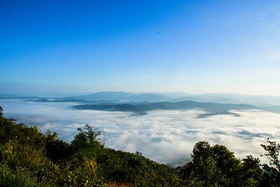 Scenic view of mountains against blue sky