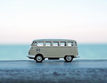 Toy car on beach against clear sky