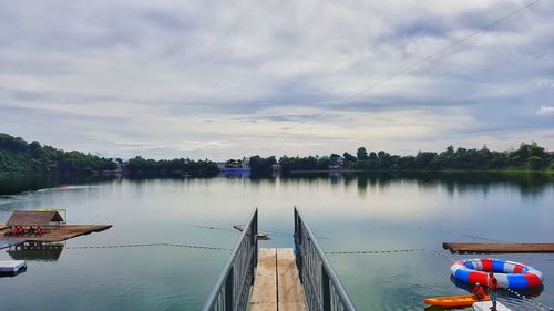 Boats moored in water against sky