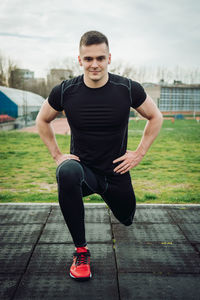 Man with hands on hip exercising at park