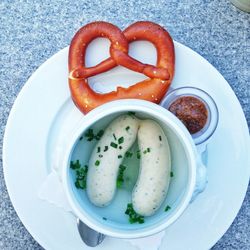 Boiled sausages served with pretzel