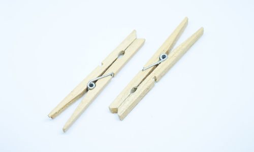 High angle view of clothespins on clothesline against white background