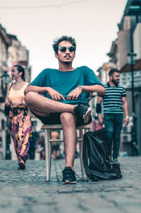 People sitting on seat in city