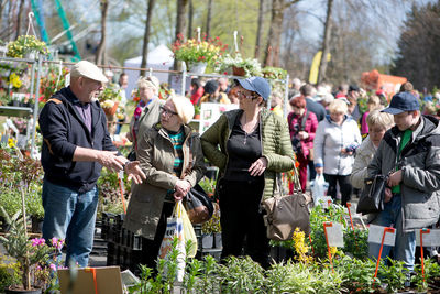 People standing by plants