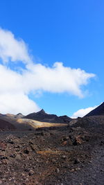 Scenic view of desert against blue sky