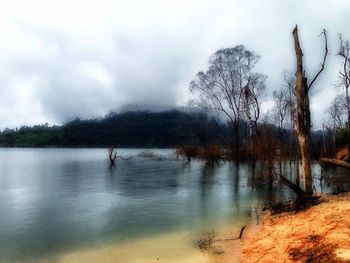 Scenic view of lake against cloudy sky