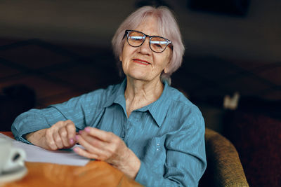 Portrait of young woman using mobile phone