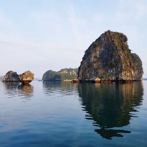 Scenic view of rock formation in lake against sky