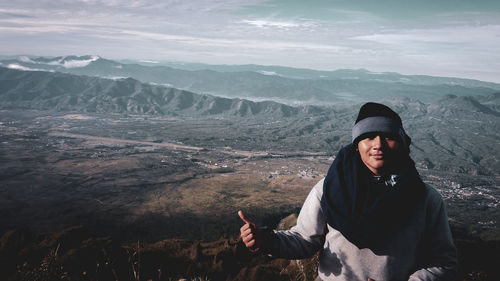 Young man standing on mountain