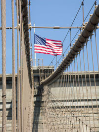 Low angle view of flag against built structure