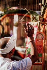 Close-up of man with hand raised