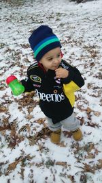 Boy wearing hat on field during winter