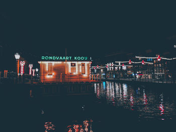 Reflection of illuminated buildings in lake at night