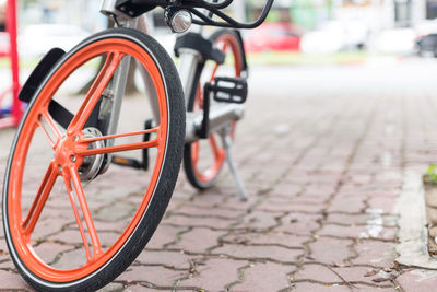 Close-up of bicycle on footpath