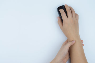 Close-up of woman hand over white background