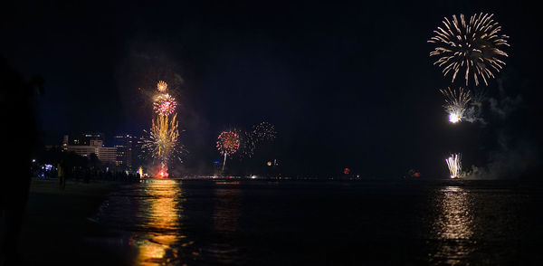 Low angle view of firework display at night