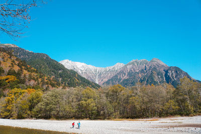 Scenic view of mountains against clear blue sky