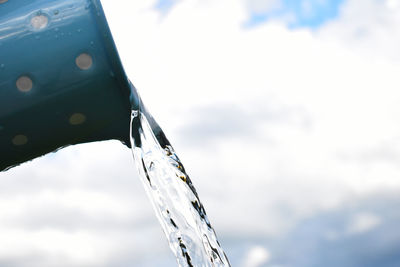 Close-up of water drop against sky