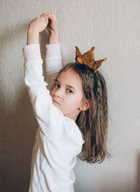 Cute toddler little girl in crown wearing pajamas play princess happy childhood.