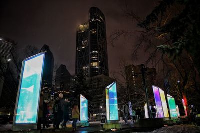 Illuminated cityscape against sky at night