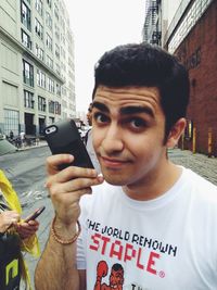 Portrait of young woman holding hands