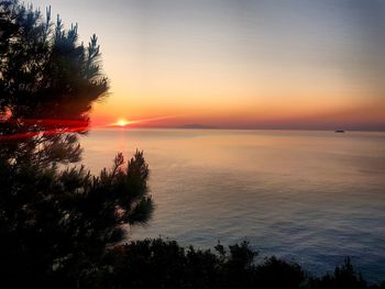 Scenic view of sea against romantic sky at sunset